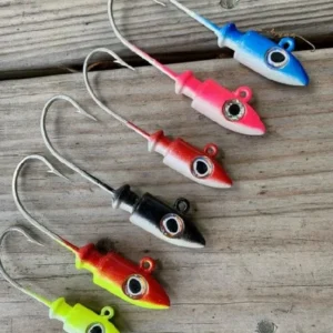 Colorful fishing lures with hooks on wood.